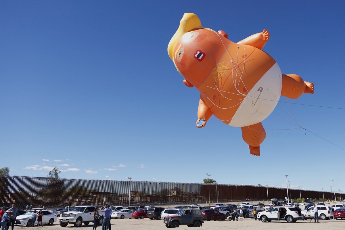 A "Baby Trump" balloon flies over the US-Mexico border fence in California as US President Donald Trump. The balloon may have inspired the Trump the Baby nickname sometimes employed by Chinese internet users to describe the American president. Photo: Reuters