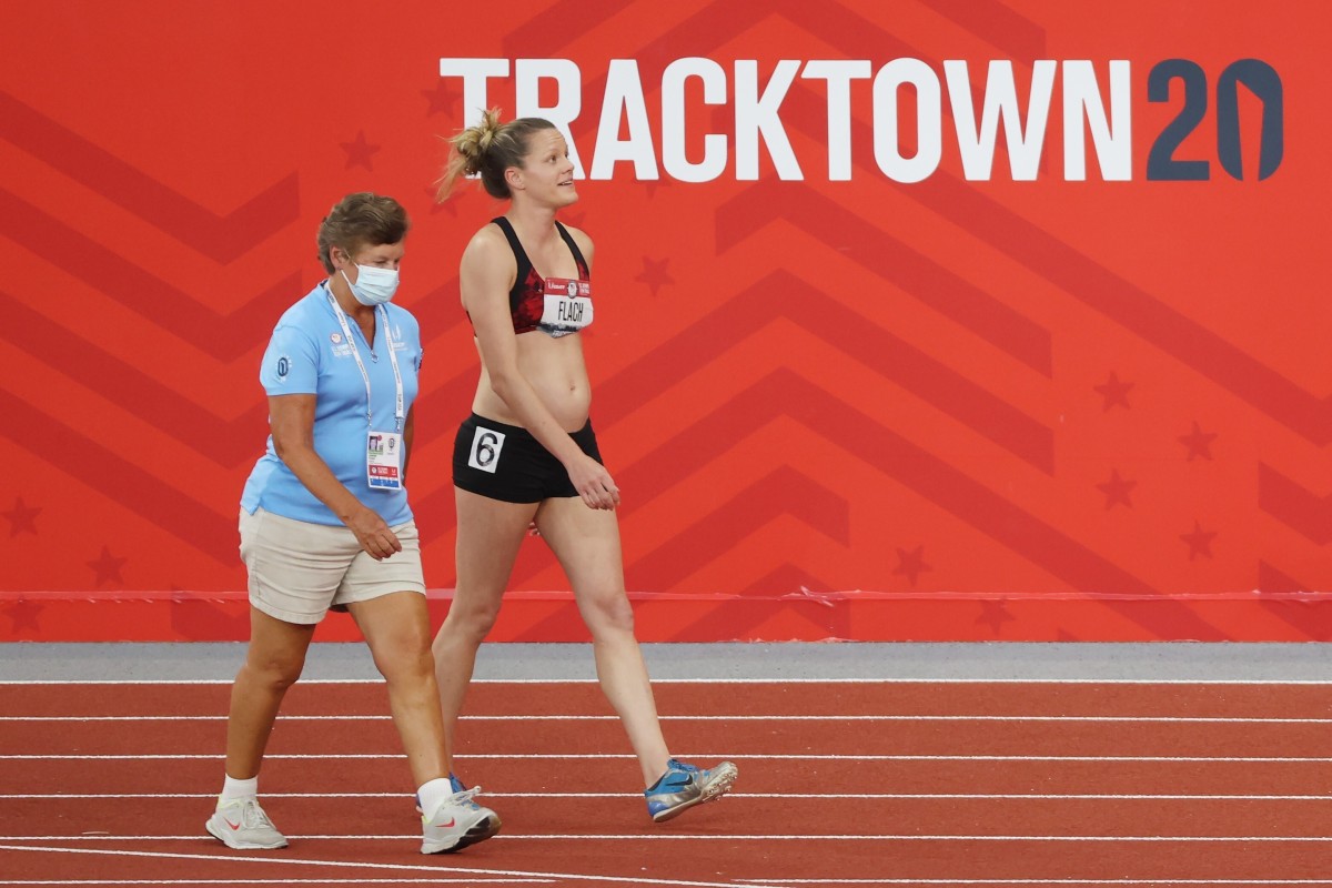 Lindsay Flach (right) walks from the track after dropping out of the US Olympic track and field trials. Photo: Getty Images/AFP