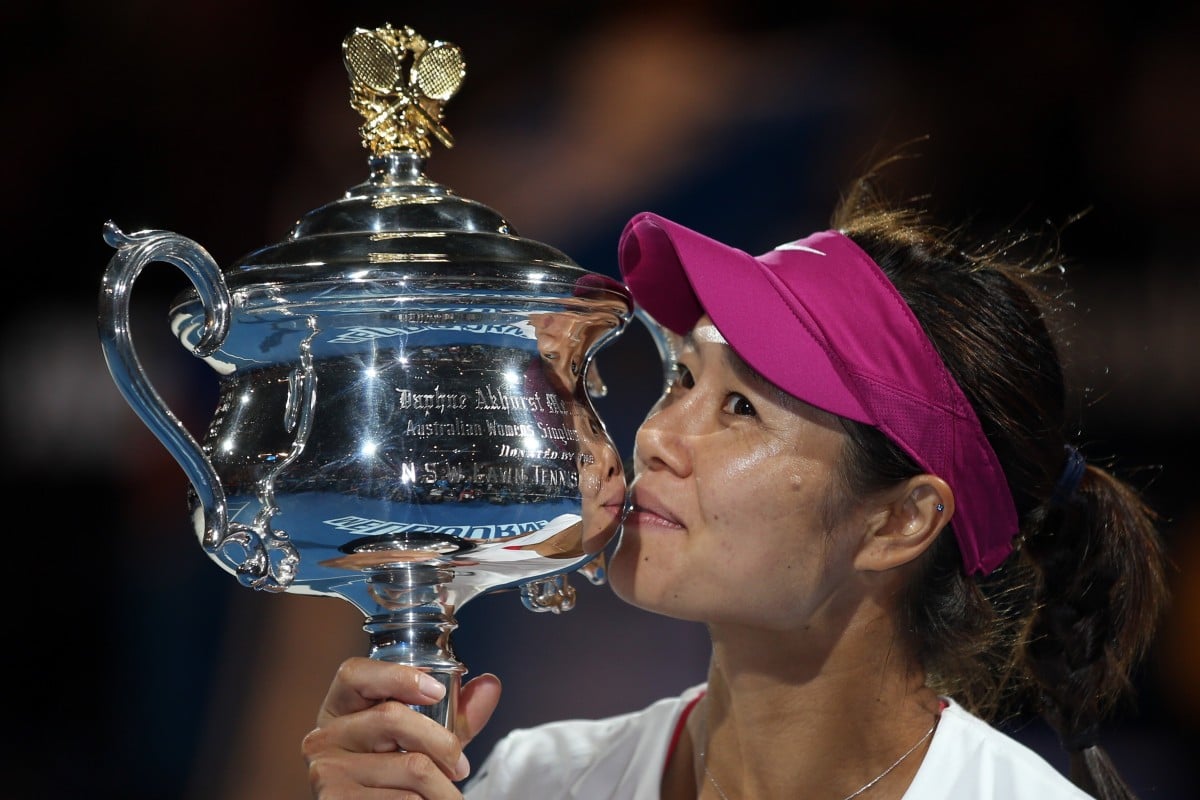 Li Na of China kisses the championship trophy after defeating Dominika Cibulkova of Slovakia in their women's singles final at the 2014 Australian Open. Photo: AP