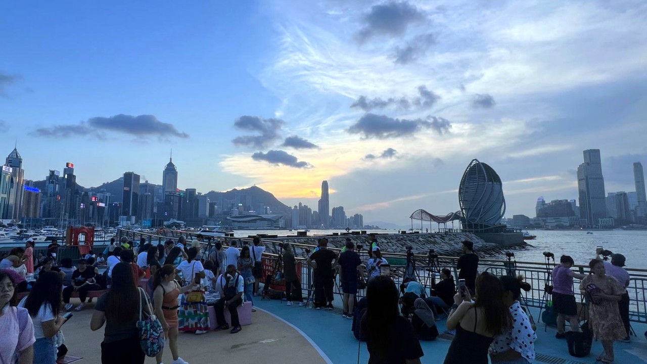 Hongkongers and tourists line Victoria Harbour hours before National Day fireworks display to bag best seats