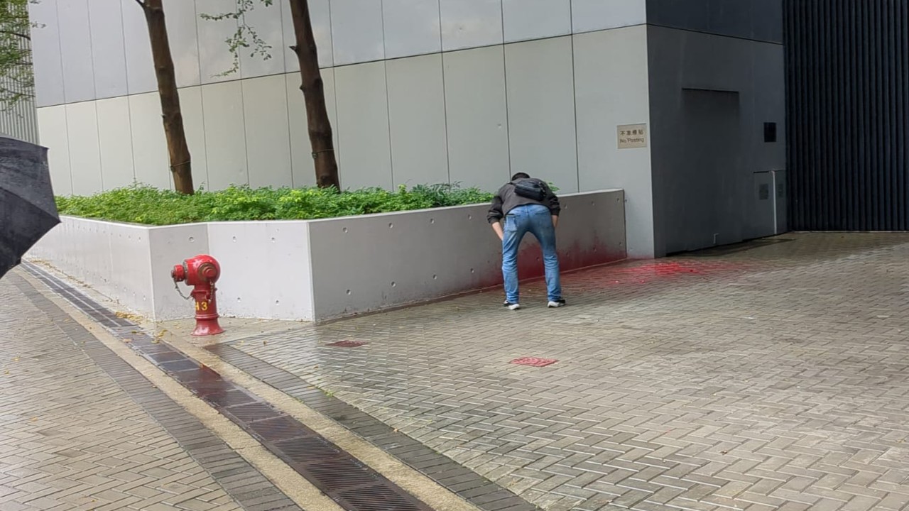 Woman arrested after red paint splashed at government headquarters in Hong Kong