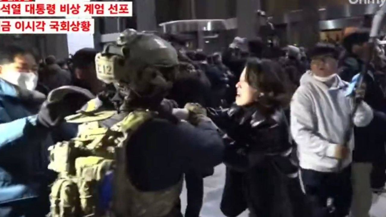South Korean politician hailed after clash with armed soldier during martial law protests