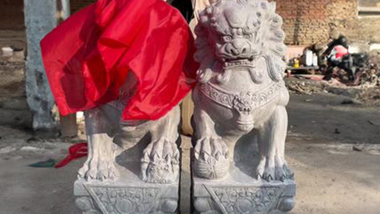 Why red cloth covers guardian stone lions in China during auspicious events