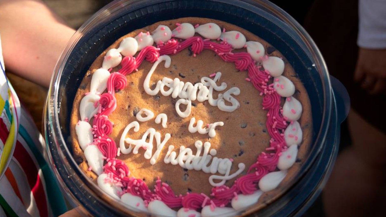 ‘We are resisting, just by existing and loving.’ Mass gay wedding at US fair raises funds