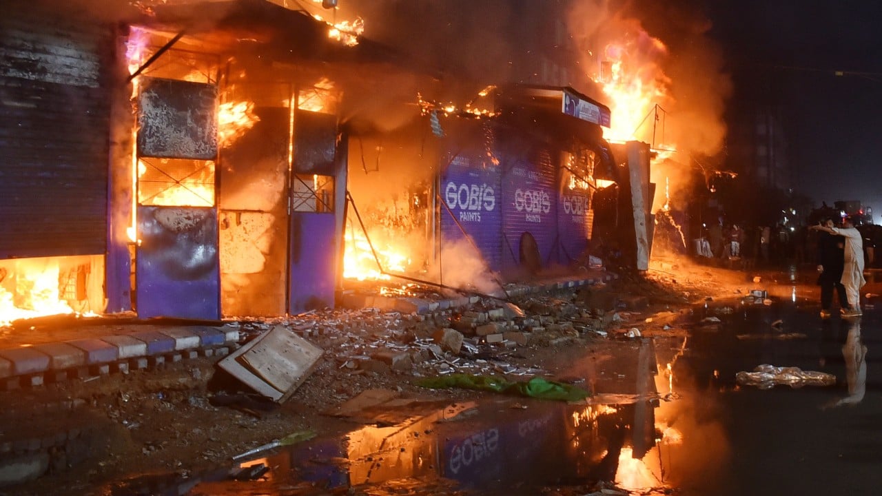 23 dead, over 60 missing after Pakistan shopping centre fire smoulders for 24 hours