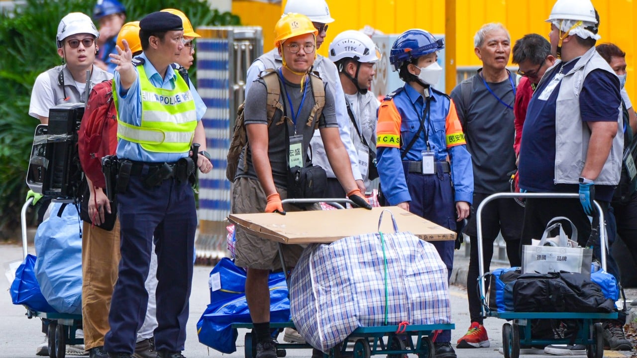 Nearly all residents of blaze-hit towers in Tai Po return to collect belongings