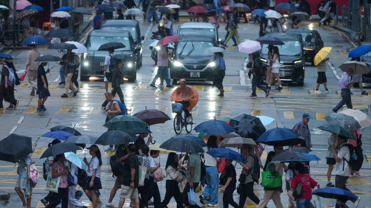 Hong Kong lowers black rainstorm warning to red after disruptions, flooding