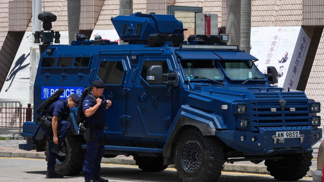 Hong Kong police search 15 in former July 1 protest areas, man taken away