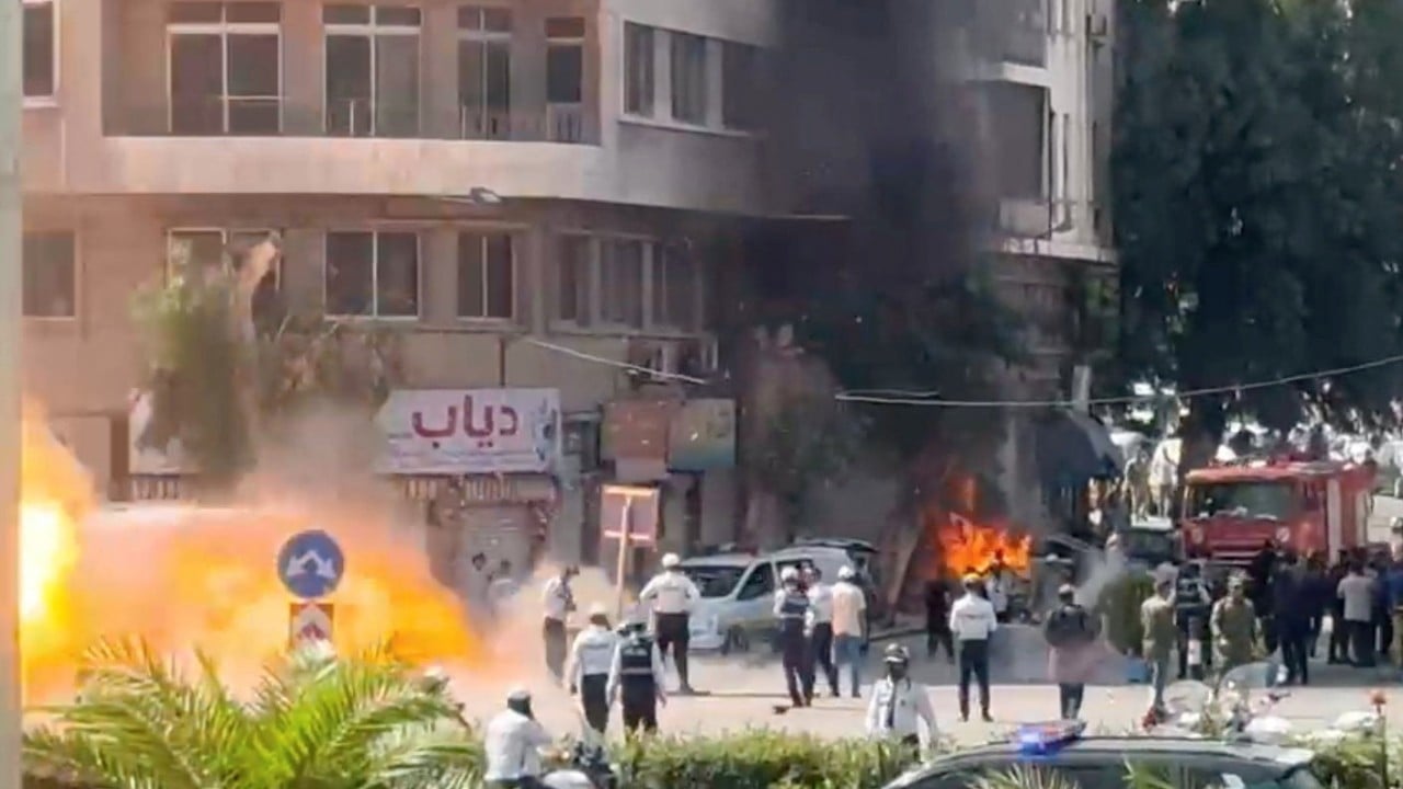 Explosions rock Damascus as France’s Macron visits Syria
