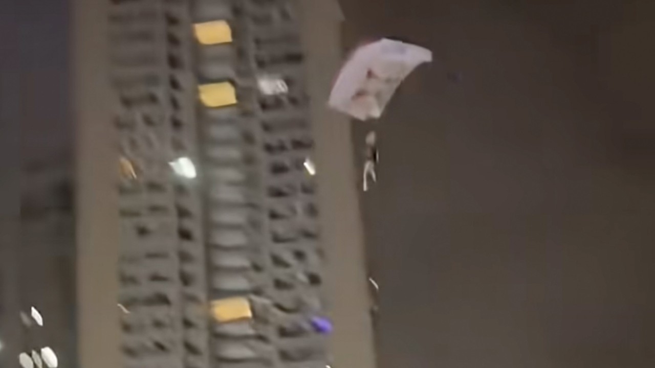 Man charged for disturbing public order in China after parachuting off residential building