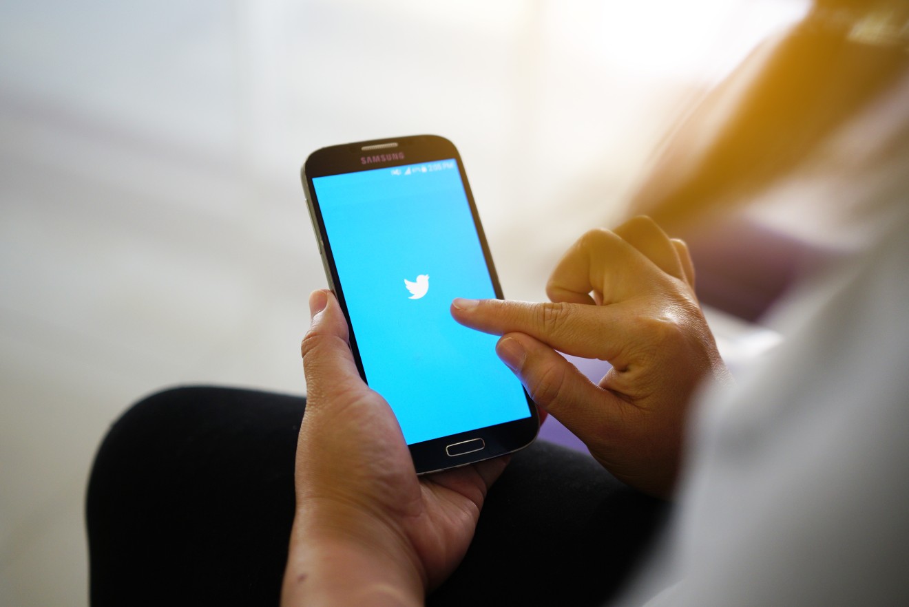This is a very realistic photo of a normal person using Twitter. Carry on. (Source: Shutterstock)