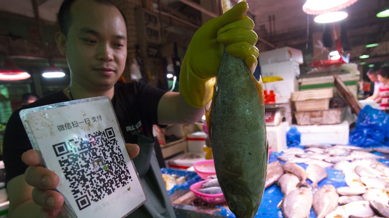 A fish vendor who takes payment by the QR code in Shenzhen, China. (Picture: South China Morning Post)  