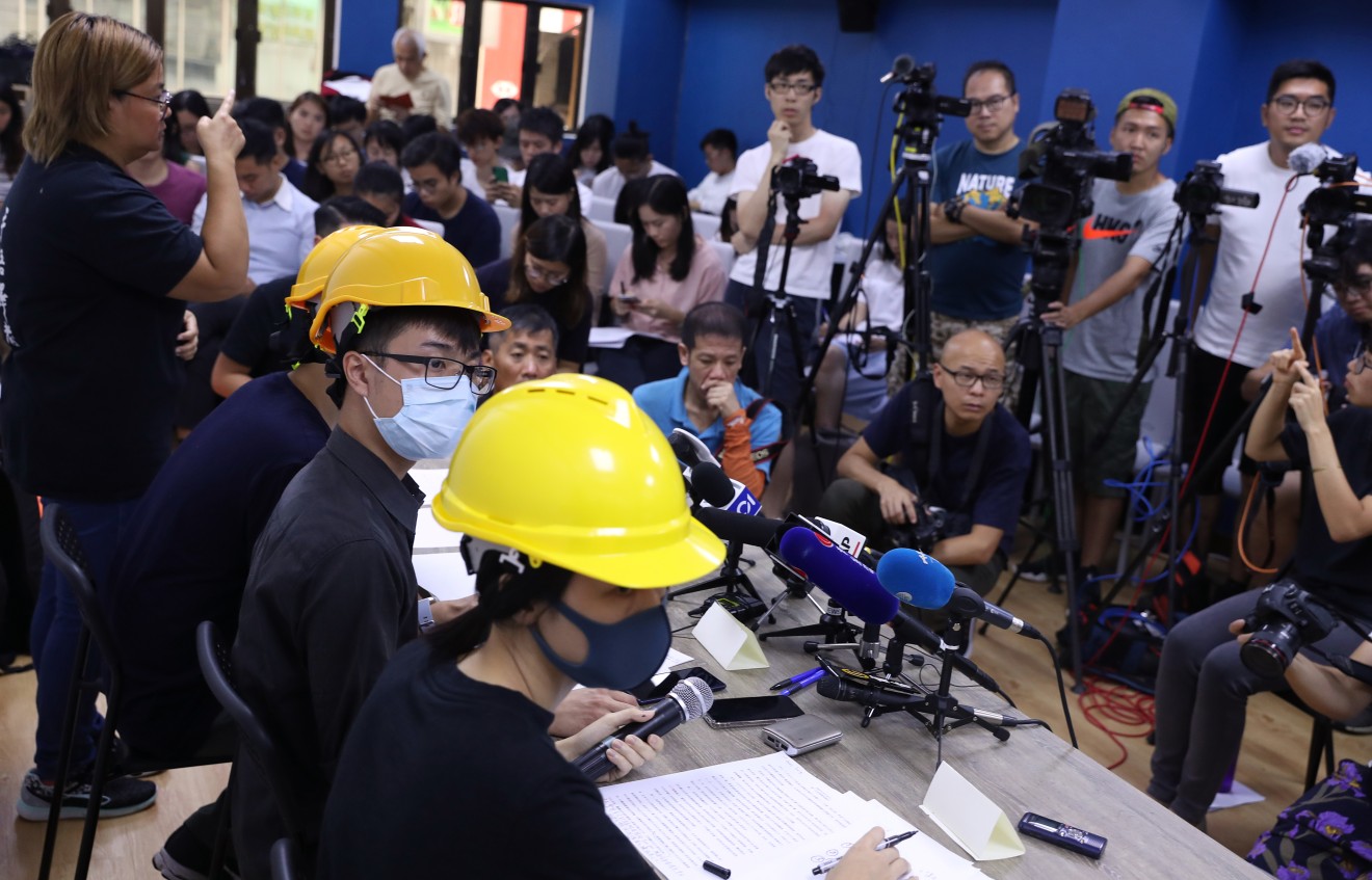 Holding press conferences in face masks and hard hats. (Picture: Sam Tsang/SCMP)