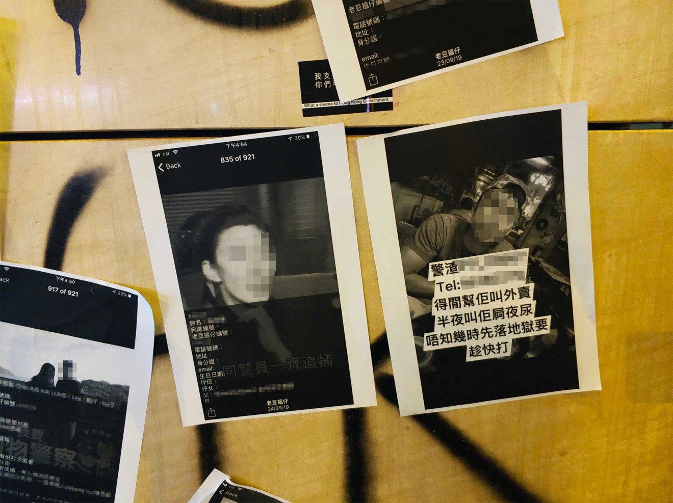 Protesters printed out pictures of police officers and pasted them on the streets of Hong Kong during a protest on China’s National Day on October 1st. We’ve blurred their faces and contact details in this photo. (Picture: Masha Borak/Abacus)