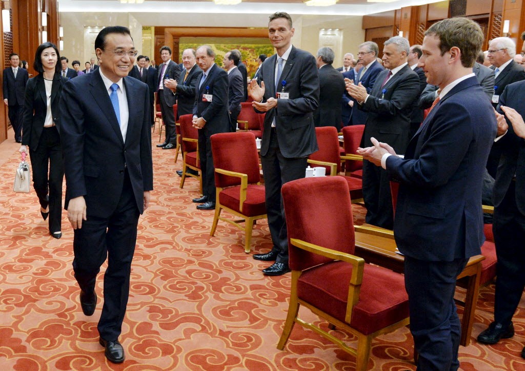 Mark Zuckerberg and overseas representatives of the China Development Forum applauding the arrival of Chinese Premier Li Keqiang at the Great Hall of the People in Beijing in 2016. (Picture: Reuters)