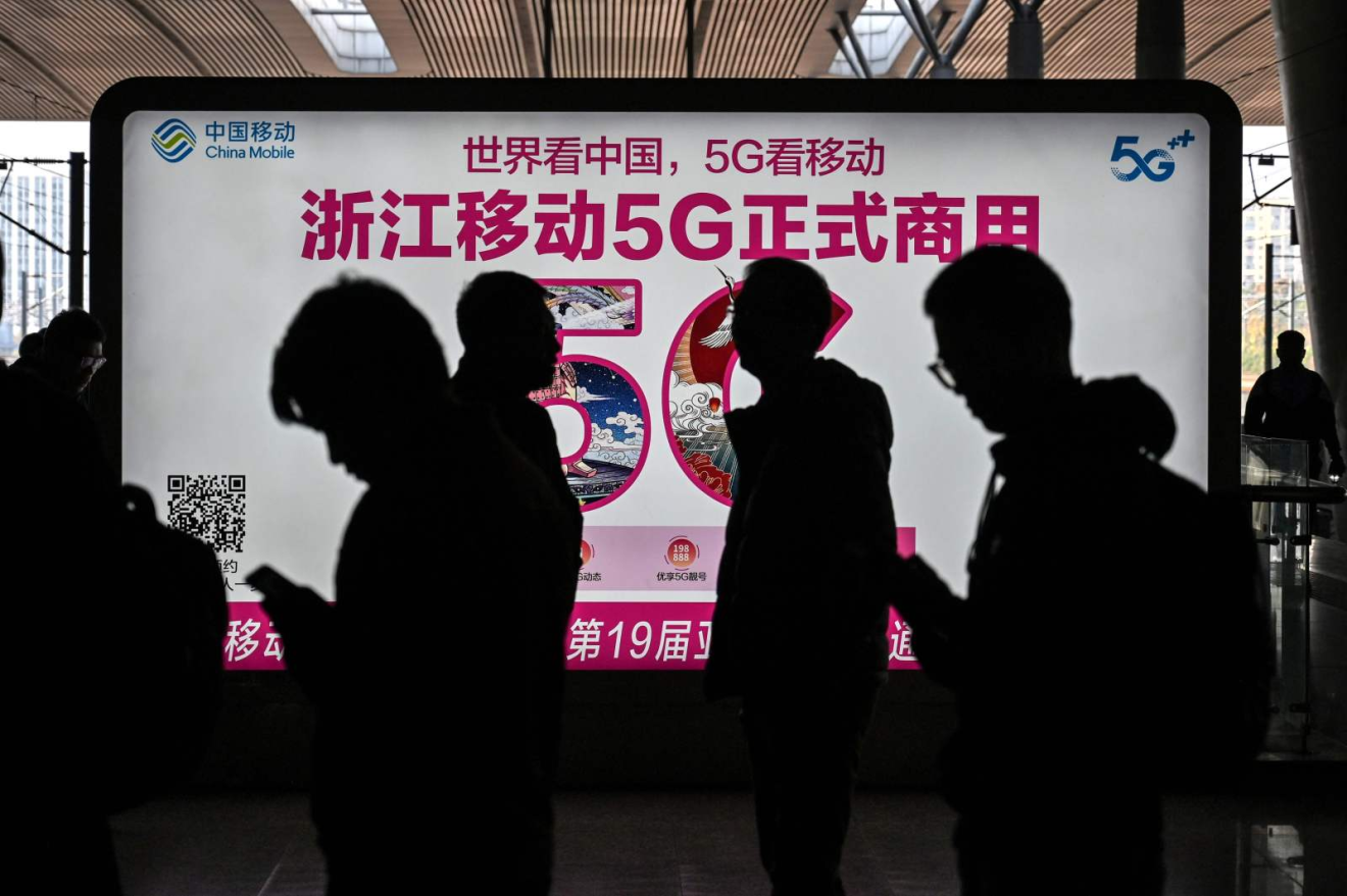A China Mobile advertisement for 5G internet at the railway station in Hangzhou on December 3, 2019. (Picture: Hector Retamal/AFP)