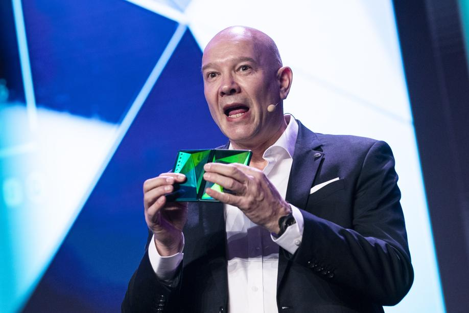A TCL Mobile representative holds a foldable version of the new TCL 10 series phone during CES 2020. (Picture: EPA)