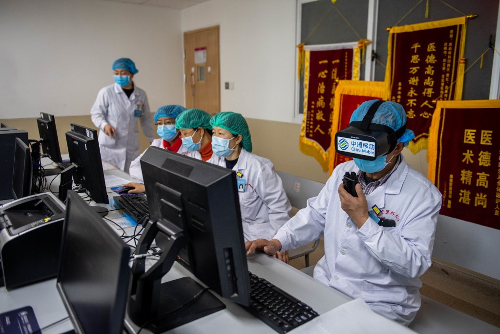 At the First Affiliated Hospital of Kunming Medical University in the southwestern Chinese province of Yunnan, a doctor wears a VR headset to check on potential Covid-19 patients in isolation. (Picture: Xinhua)