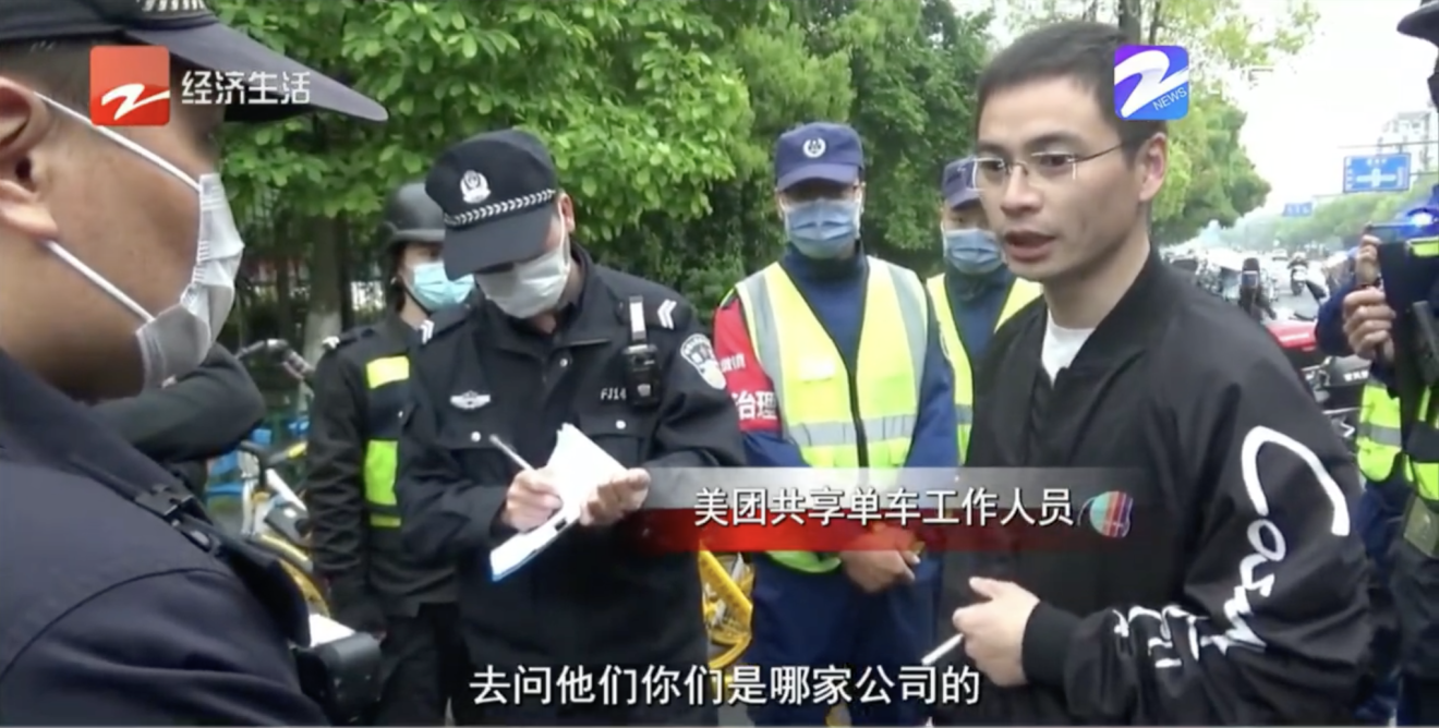 A Meituan employee accuses Hellobike workers of removing his company’s bikes. (Picture: Zhejiang Television)