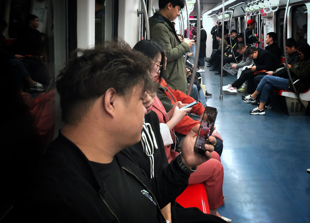A couple watch a video on Douyin on the Beijing subway. (Picture: Simon Song/SCMP)