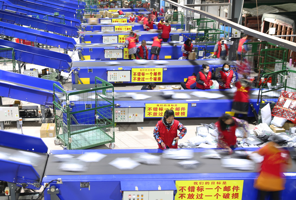 Workers at a China Post distribution center sorting out Singles Day packages in 2018. (Picture: Cao Zhengping/Xinhua)  