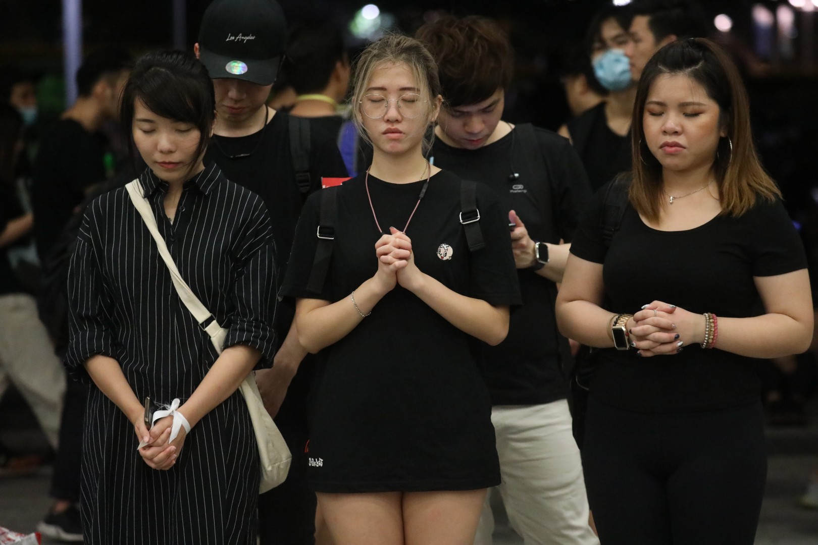 As a peaceful protest march concludes in Hong Kong, those who remain on the streets pray for the city's future. Photo: Dickson Lee