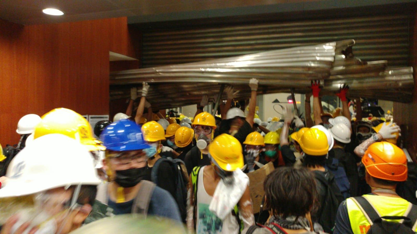 Protesters storm in the legislature after hours of mayhem outside. Photo: Felix Wong