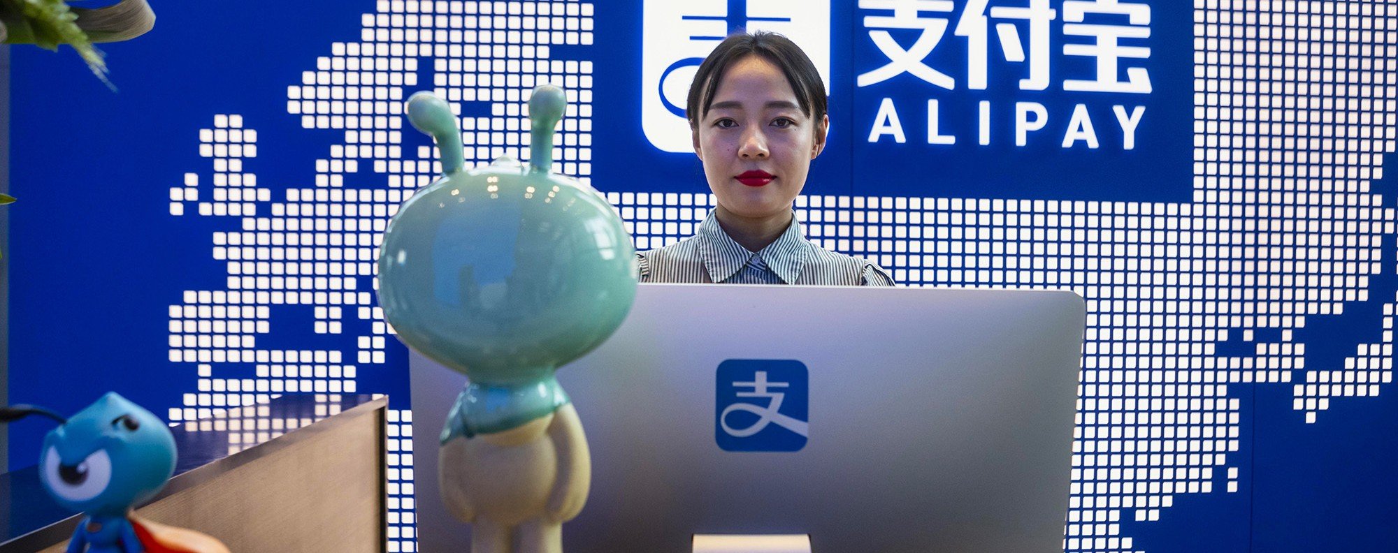 An employee stands at the reception desk of the Alipay and Ant Group headquarters building in Shanghai. Photo: EPA-EFE