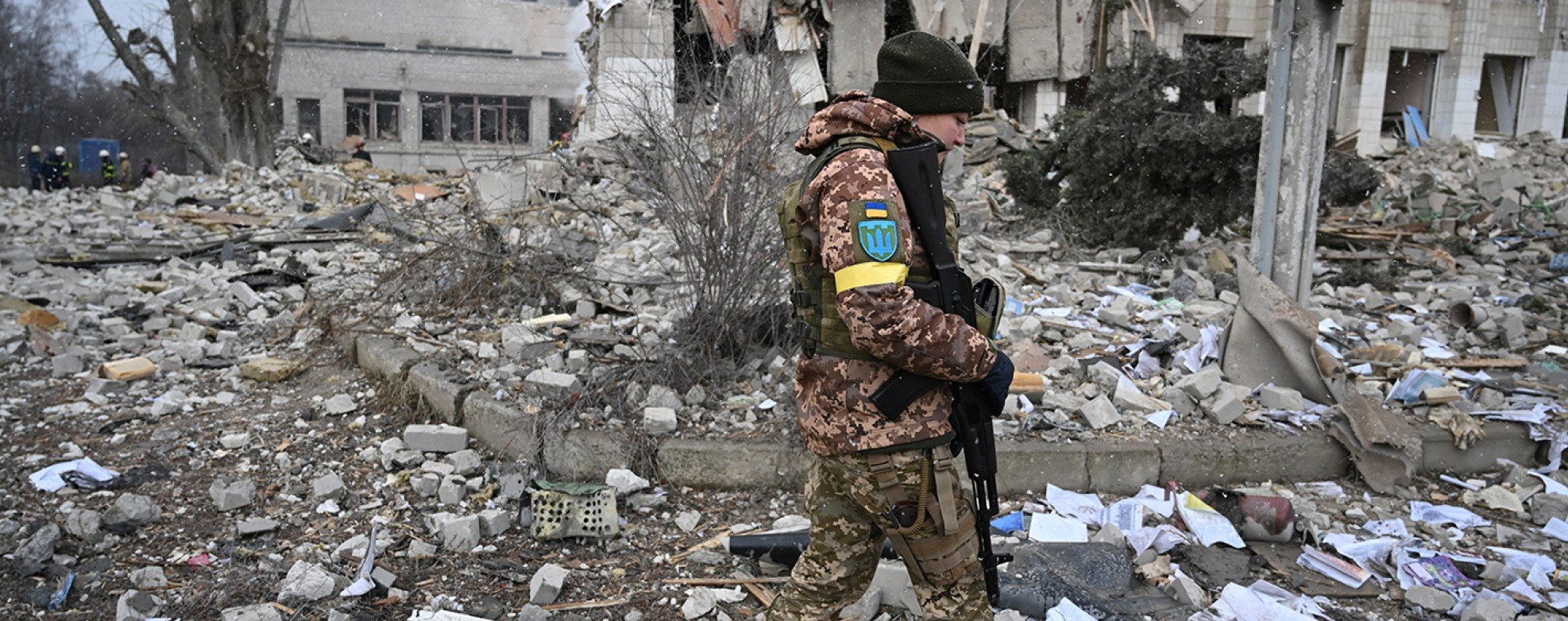A Ukrainian soldier walks near a school building destroyed by shelling in Zhytomyr. Photo: Reuters