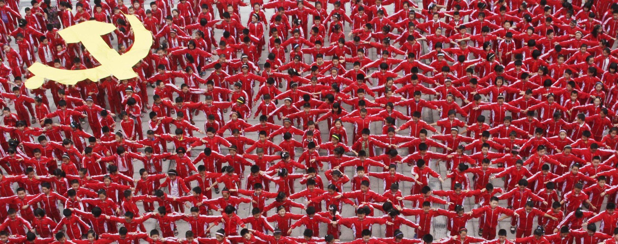 Students in school uniforms link their arms to form the flag of the Communist Party of China, in celebration of the party's upcoming 90th anniversary in July 2011. Photo: Reuters/China Daily 