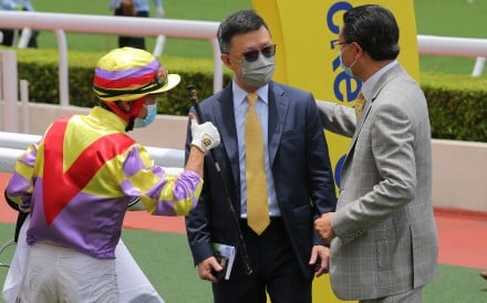 Peter Ho is congratulated by jockey Dylan Mo after Dashing Triumph’s debut success. Photo: Kenneth Chan