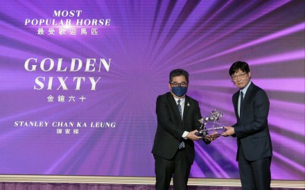 Golden Sixty’s owner Stanley Chan Ka-leung picks up the award for Most Popular Horse of the Year. Photo: HKJC