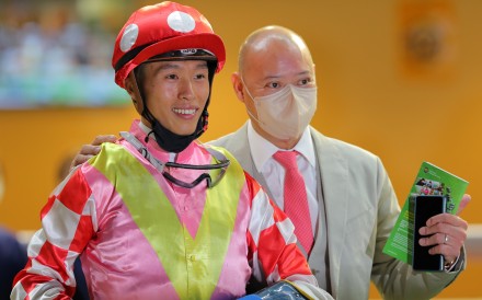 Jockey Vincent Ho celebrates Happily Friends’ victory with trainer Chris So. Photo: Kenneth Chan