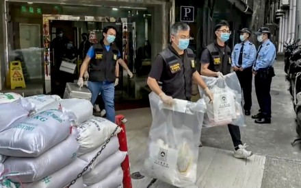 Macau police seize evidence from a hotel room where a woman’s body was found. Photo: Handout
