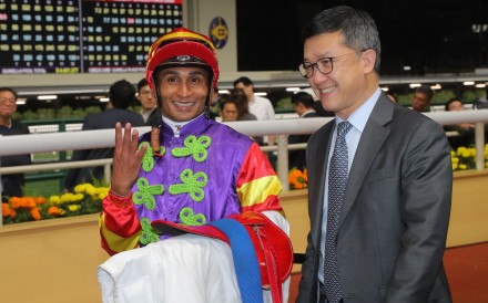 Jockey Karis Teetan celebrates his Happy Valley four-timer with trainer Peter Ho. Photo: Kenneth Chan