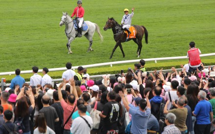 Jockey Vincent Ho waves to the crowd after Golden Sixty’s Champions Mile victory at Sha Tin on Sunday. Photo: Kenneth Chan