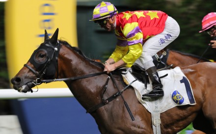 Zac Purton salutes aboard Romantic Laos to ring up his 600th Happy Valley winner. Photo: Kenneth Chan