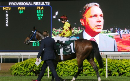 Zac Purton and Southern Legend return after winning the 2019 Kranji Mile, while trainer Caspar Fownes is interviewed on the big screen. Photos: Kenneth Chan