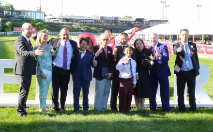 Assistant trainer Ben So (fourth from left), owner Peter Lau (fifth from left) and trainer Danny Shum (fifth from right) celebrate Romantic Warrior’s epic Cox Plate victory with family and officials. Photos: Kenneth Chan