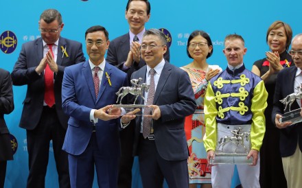 Jockey Club chairman Michael Lee presents Francis Lui with his champion trainer trophy. Photos: Kenneth Chan