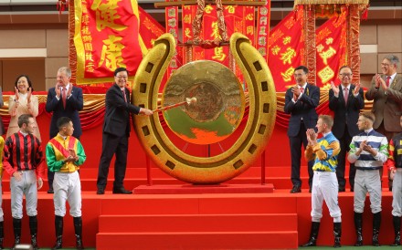 Chief Executive John Lee strikes the gong to open the racing season at Sha Tin on Sunday. Photo: Kenneth Chan