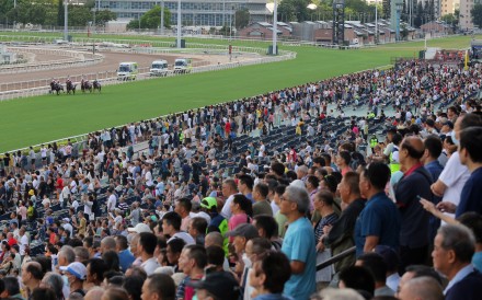 A healthy crowd cheers as the field powers down the Sha Tin straight. Photos: Kenneth Chan