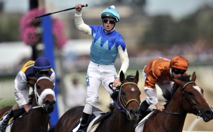 Zac Purton celebrates winning the 2014 Caulfield Cup on Japanese raider Admire Rakti. Photo: EPA