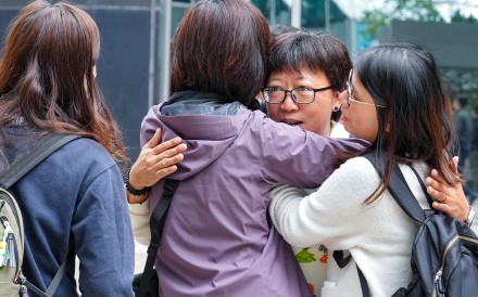 Social worker Jackie Chen arrives at the Hong Kong District Court to hear the verdict on her retrial, and is greeted by supporters. Photo: May Tse