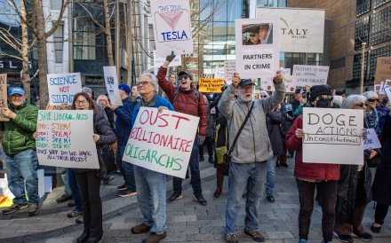 People protest against Elon Musk and Tesla outside a Tesla showroom in Boston, US, on March 15. Photo: FP/Getty Images/Tribune News Service