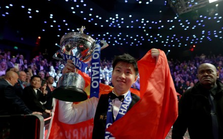 Zhao Xintong celebrates with the trophy after claiming the title by defeating Mark Williams of Wales in the final at World Snooker Championship. Photo: Xinhua