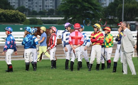 Jockeys mill around during delays to the start of race 10 at Sha Tin on Sunday. Photos: Kenneth Chan