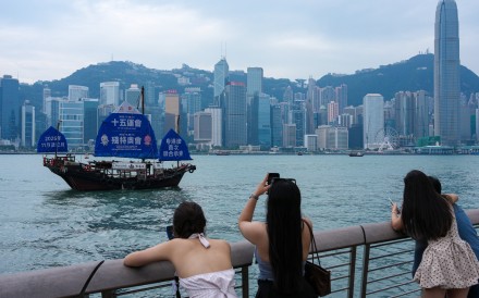 A Chinese sailboat with a giant poster for the 15th National Games and the Special Olympics sails through Victoria Harbour in Tsim Sha Tsui. Photo: Jelly Tse