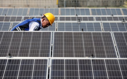 A technician checks and cleans solar panels at Jatijajar bus station in Depok, Indonesia, on April 16. Photo: EPA-EFE