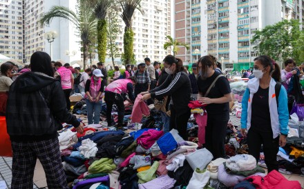 Volunteers help with gathering clothes, lunch boxes and drinks for victims at Kwong Fuk Estate. Photo: Sam Tsang